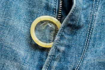 Condom on the jeans. Safe sex concept. Health care medicine, contraception and birth control.