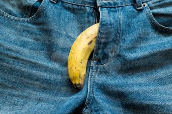 Banana sticking out of men's jeans. Banana out of mens jeans like mens penis,potency concept