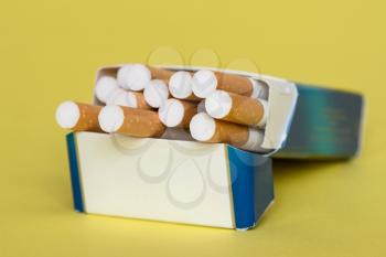 Open cigarettes in pack and tobacco. STOP Smoking. Cigarette with brown filter in the box