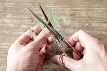 Scissors cutting paper cut of family. Broken family or divorce concept