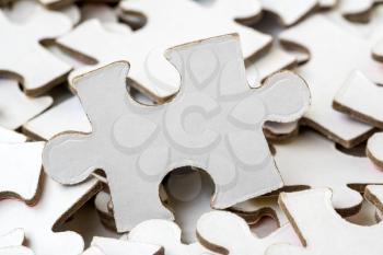 Pile of white jigsaw puzzles pieces