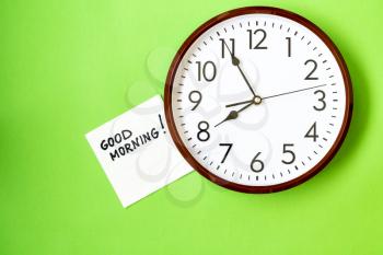 Wall clock with GOOD MORNING note on napkin