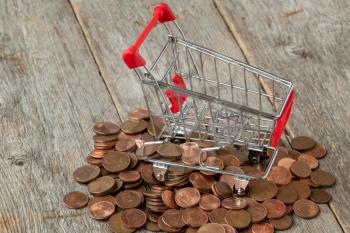 Small shopping cart and scattered coins