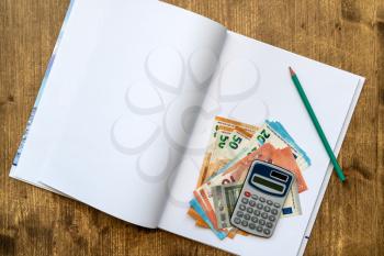 Banknotes and Calculator with Notebook. European currency