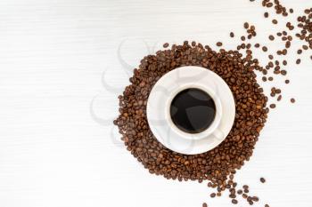 Coffee cup and coffee beans on wooden table. Top view,copy-space.