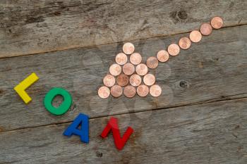 Combination of coin arrow and word LOAN made from colored plastic letters