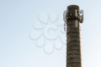 Telecommunication antennas mounted on top of industrial chimney 