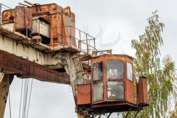 Old rusty lifting crane stands outdoors