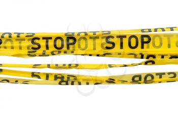 Barrier tape for no entry at an construction site or crime zone.  STOP tapes isolated on white background.
