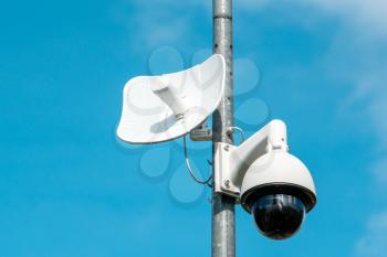 Video camera security system on a pole with blue sky background