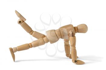 Wooden man doing fitness exercises , isolated on white background