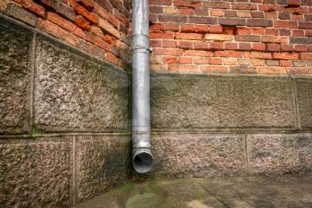 Rainwater drainage pipe on the old building wall