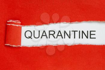 Top view of red torn paper and the text QUARANTINE on a white background. Healthcare and medical concept.