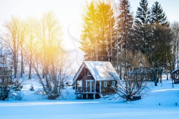 Wooden hut in forest in winter scenery