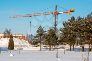 Tower crane on construction site in cold winter weather