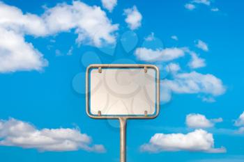 Blank metal sign post against blue sky, put your own text here