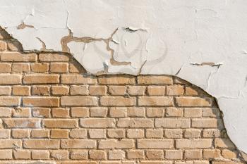 Plastered Brickwall With Chipped Stucco Pieces. White Brick Wall With Damage Surface. Old Grunge Abstract Background.