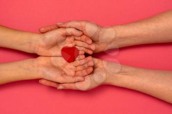 Adult and child hands holding red heart. Health care, donate and family insurance concept,world heart day, world health day, adoptive foster family,concept