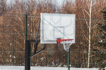 Outdoor basketball hoop with net, covered by hoarfrost