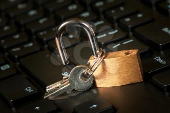 Open security lock on computer keyboard - computer security breach concept