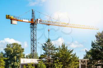 Construction site with a tower crane in a sunny summer day