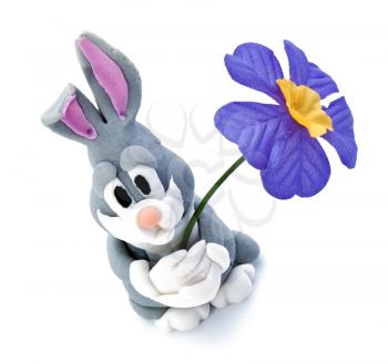 Easter bunny from marcipan with flower on white