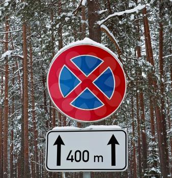 No parking sign on the next mark in the winter forest