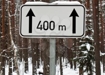 Traffic sign next 400 meters in winter forest