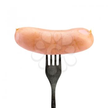 Sausage on a silver fork isolated on white background