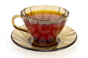 Tea in a brown glass cup isolated on white background