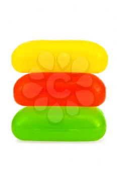 Three pieces of soap in red, yellow and green isolated on white background