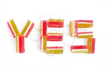 The word yes out of a multi-colored jelly isolated on a white background