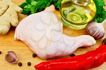One chicken leg, vegetable oil in a bottle, pepper red sharp, a ginger root, garlic on a wooden board