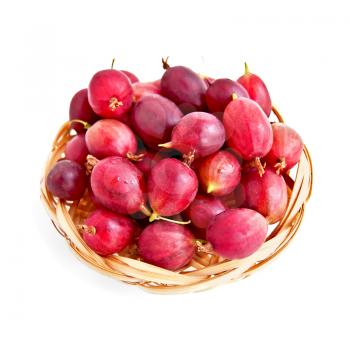 Berries of red gooseberries on a straw wicker plate isolated on a white background