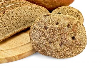 Two rye bread, sliced brown bread on a wooden board isolated on white background