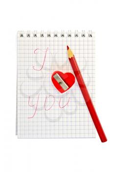 Sharpener in the shape of a red heart with a pencil and a notebook labeled isolated on white background