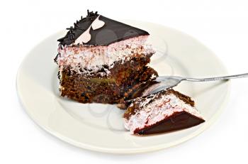 A piece of chocolate cake with pink cream with the broken spoon on a plate isolated on white background
