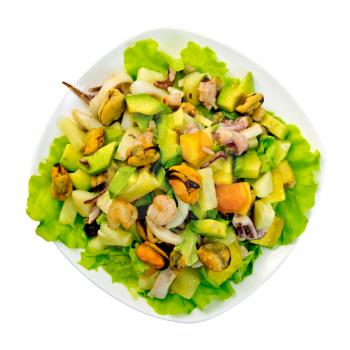 Salad from shrimps, octopus, mussels and calamari with avocado, lettuce, pineapple in plate isolated on white background top