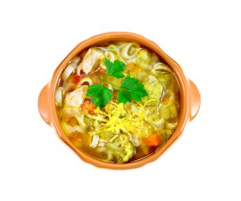 Minestrone soup with meat, celery, tomatoes, zucchini and cabbage, green peas, carrots and pasta in a clay bowl isolated on white background on top