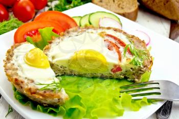 Tartlets meat with egg and tomato cut in the plate on lettuce, bread and dill on the background wooden boards