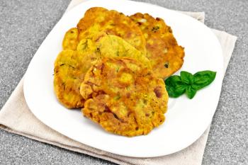 Indian chick-pea flour flatbreads with zucchini and fresh herbs in a plate on a napkin on a background granite table