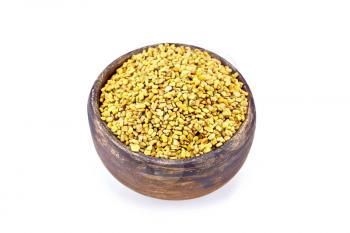 Fenugreek seeds in a brown clay bowl isolated on white background