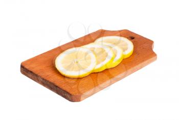 Slices of lemon  on wooden cutting board  isolated on  white