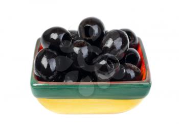 Black pitted olives in colored ceramic ware isolated  on  white