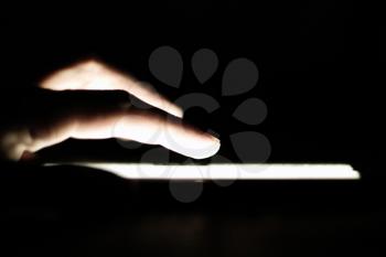 Royalty Free Photo of a Hand Touching a Screen on a Tablet