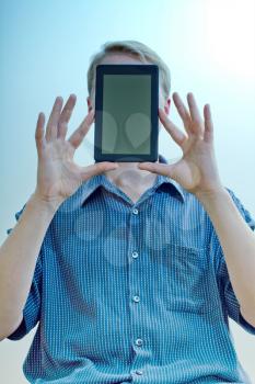 Royalty Free Photo of a Man Holding a Tablet in Front of His Face