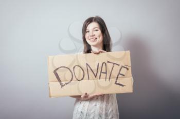 girl holding a poster with an inscription a donation