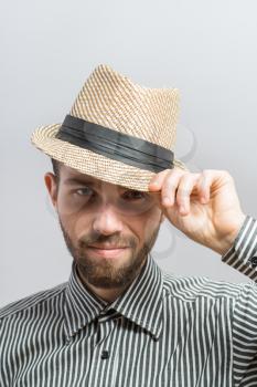 Portrait of handsome bearded man in hat standing