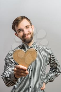 A happy man holding  heart made of cardboard
