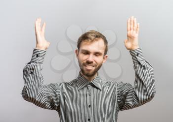 Half-length portrait of manager praying with hands up, isolated on gray. Concept of hope and belief